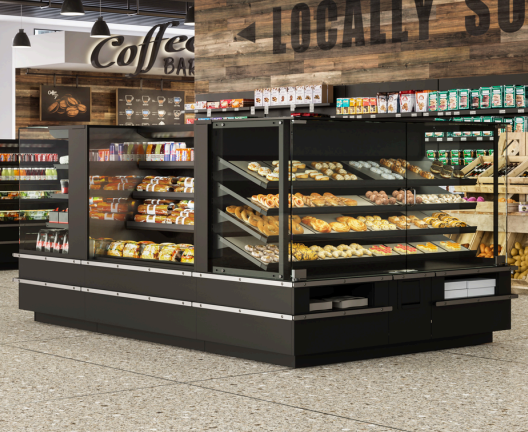 Black refrigerated bakery and grab-and-go display cases showcasing fresh bread, pastries, packaged snacks, and beverages in a modern convenience store with a coffee bar. The open-air and glass-front merchandisers maximize product visibility while creating an inviting fresh food destination.